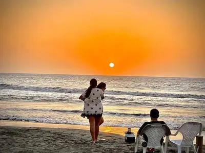 a woman walking on the beach at sunset at Morros Zoe - Beautiful Apartment on Manzanillo Beach in Cartagena de Indias