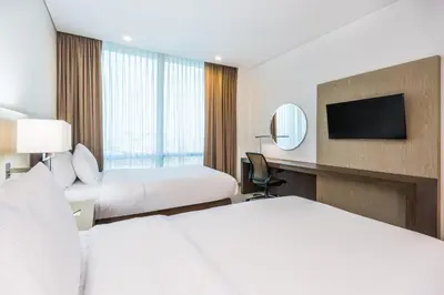 a hotel room with two beds and a television at Hilton Garden Inn Barranquilla in Barranquilla