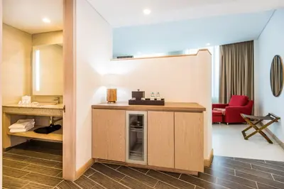 a room with a desk and a red chair at Hilton Garden Inn Barranquilla in Barranquilla