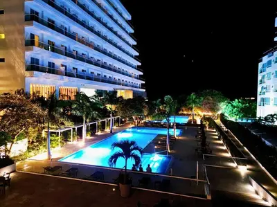 a large swimming pool in front of a building at night at Moderno 3 hab con la mejor Vista en playa dormida Santa Marta in Santa Marta