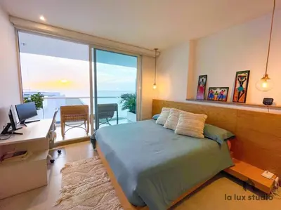 a bedroom with a bed and a desk with a computer at Moderno 3 hab con la mejor Vista en playa dormida Santa Marta in Santa Marta