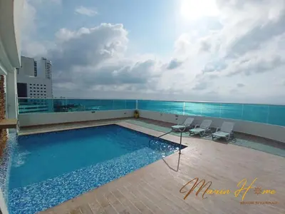 a swimming pool on the roof of a building at 2BR Oceanfront Apartment - Direct Beach Access - Modern and Spacious - 6th Floor in Cartagena de Indias