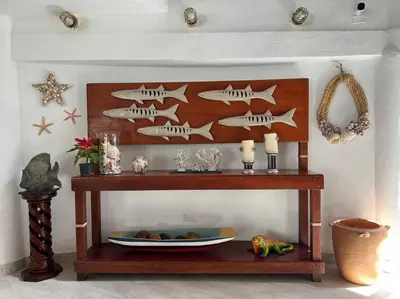 a wooden shelf with fish on it in a room at Casa El Faro, Hermosa casa de playa in Cartagena de Indias