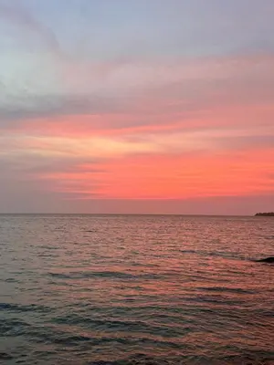 a sunset over a body of water at Thani Ecobeach Barú in Playa Blanca