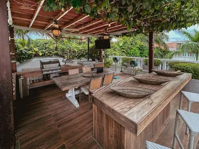 an outdoor patio with wooden tables and chairs at Casa Belle Cartagena Hotel Boutique in Cartagena de Indias