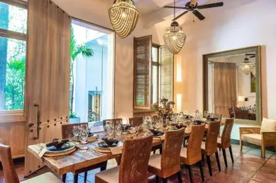 a dining room with a large wooden table and chairs at Casa Belle Cartagena Hotel Boutique in Cartagena de Indias