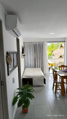 a living room with a bed and a table and a table at Apartamento 201 Palmar de los vientos in San Bernardo del Viento