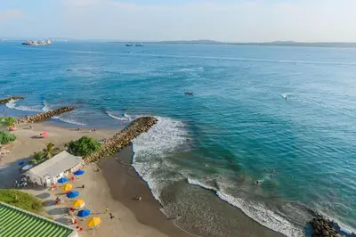 an aerial view of a beach with umbrellas and the ocean at U-GO Playa Mar en El Laguito con Vista al Mar in Cartagena de Indias