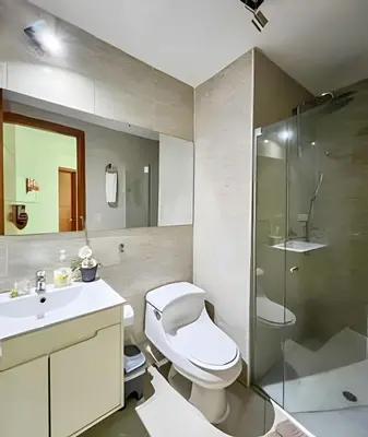 a bathroom with a toilet and a glass shower at Apartamento 2 Dormitorios Laguito. Vista Mar in Cartagena de Indias