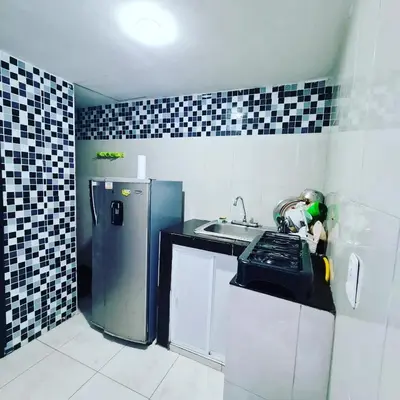 a small kitchen with a refrigerator and a sink at Apartamentos La Marina in Cartagena de Indias