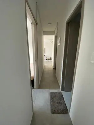a hallway with white walls and a hallway with a rug at Apto Boho in Cartagena de Indias