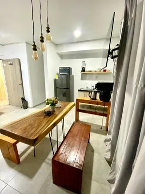 a living room with a wooden table and a bench at Apto Boho in Cartagena de Indias