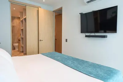 a bedroom with a bed and a flat screen tv at Tres habitaciones - Vista al Mar in Cartagena de Indias