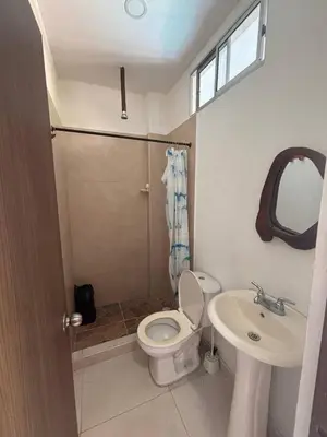 a bathroom with a toilet and a sink at Hostal Los Arhuacos in Santa Marta