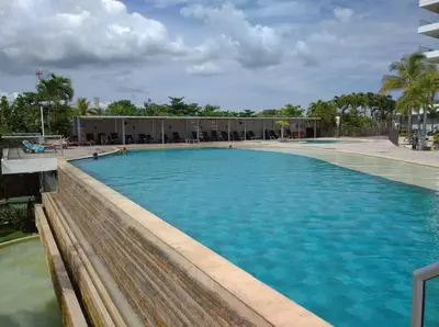 a large pool with blue water in front of a building at Sensacional Apartamento nuevo frente al mar in Cartagena de Indias