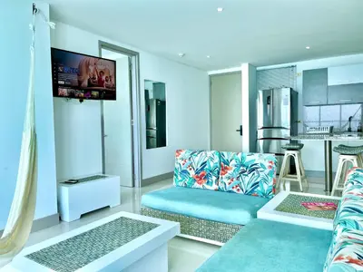 a living room with a couch and a kitchen at by Calamari Homes - Palmetto Beach 2504 Bocagrande in Cartagena de Indias