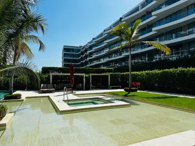 a courtyard with a swimming pool in front of a building at Fantastic Apartment/Beach Front Luxury in Cartagena de Indias