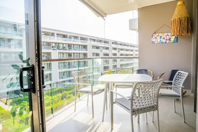 a dining room with a table and chairs and a large window at Fantastic Apartment/Beach Front Luxury in Cartagena de Indias