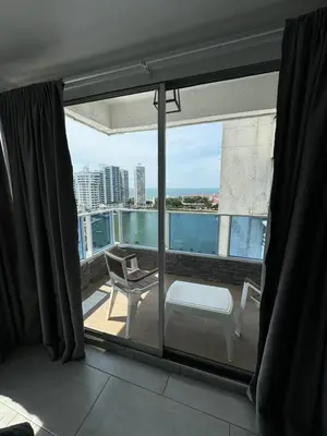 a room with a balcony with a view of the ocean at Hermoso Apartamento vista al mar El Laguito in Cartagena de Indias