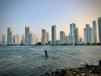 a person in the water in front of a city at Hermoso Apartamento vista al mar El Laguito in Cartagena de Indias