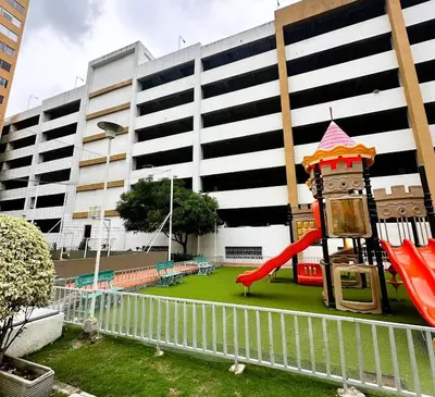 a playground in front of a building with a slide at Apartamentos Condominio Oporto - Cerca a Todo in Barranquilla