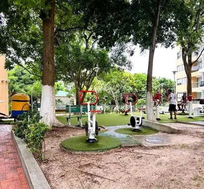 a park with a playground with benches and trees at Apartamentos Condominio Oporto - Cerca a Todo in Barranquilla