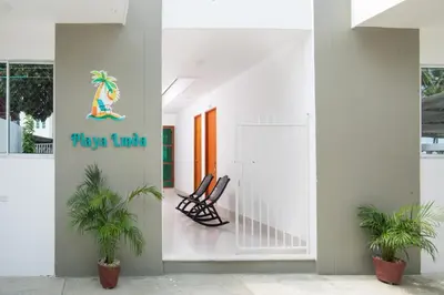 a lobby with two chairs and a sign that reads play turtle at Habitacion Playa Linda 103 in Coveñitas