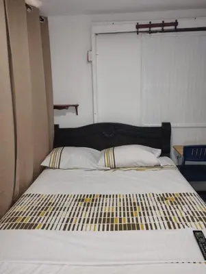 a bedroom with a large bed with a black headboard at Habitación privada en Bocagrande in Cartagena de Indias