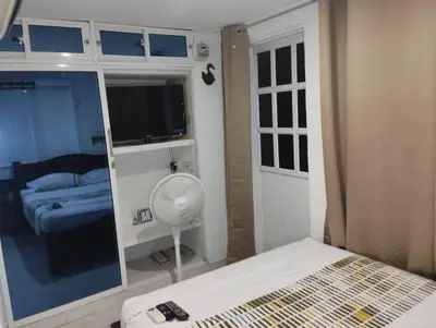 a bedroom with a bed and a tv and a window at Habitación privada en Bocagrande in Cartagena de Indias