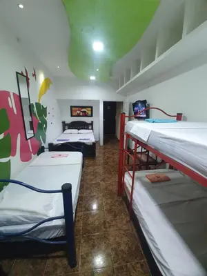a dorm room with three bunk beds in it at CASA ZOÉ in Cartagena de Indias