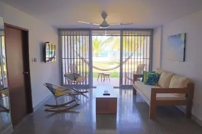 a living room with a couch and a chair at Magico Apartamento Frente al Mar 3 Habitaciones C11A in Coveñas