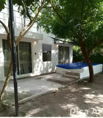 a white house with a blue bench in front of it at casa de vacaciones tierra bomba cartagena de indias in Tierra Bomba