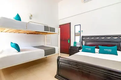 a bedroom with two bunk beds with blue pillows at Ayenda Casa Amarilla in Santa Marta