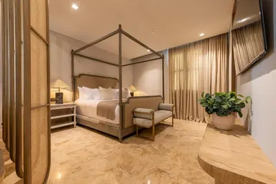 a bedroom with a canopy bed and a chair at Cinco Quintas Hotel Boutique in Cartagena de Indias