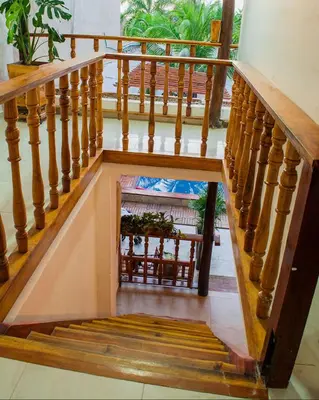 a stairway with a wooden railing and a stair case at Hb3 Double Room with private bathroom facing the sea in Cartagena de Indias