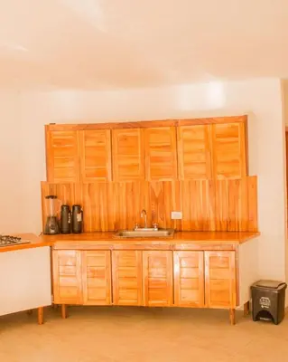 a kitchen with a sink and wooden cabinets at Hb3 Double Room with private bathroom facing the sea in Cartagena de Indias