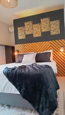 a bedroom with a bed with a black comforter at Hb4 Double Room with Private Bathroom and Balcony in Cartagena de Indias