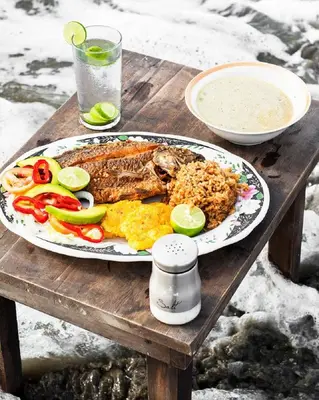 a plate of food on a wooden table at Hb4 Double Room with Private Bathroom and Balcony in Cartagena de Indias