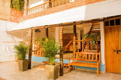 a porch of a house with a bench and plants at Hb1 Triple Room With Air Conditioning And WIFI in Cartagena de Indias