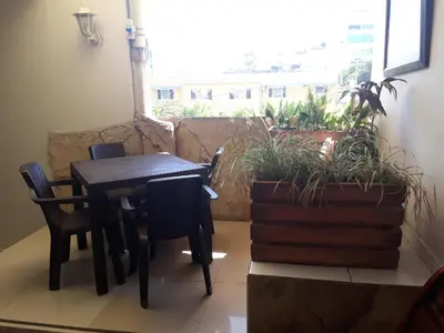 a table and chairs in a room with a window at Hotel Granada Inn in Barranquilla