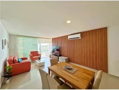 a living room with a table and a dining room at Acogedor Marbella ideal familias mínimo 2 días in Cartagena de Indias