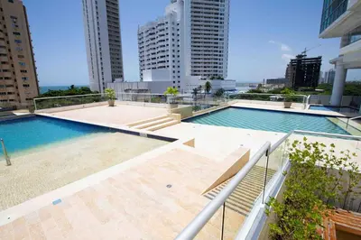 a swimming pool on top of a building with tall buildings at Acogedor Marbella ideal familias mínimo 2 días in Cartagena de Indias