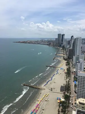 a view of a beach with umbrellas and the ocean at Apartamento Fantástico in Cartagena de Indias