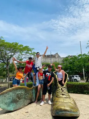 a group of people posing in front of a large fish statue at Cartagena Kings Hostel in Cartagena de Indias