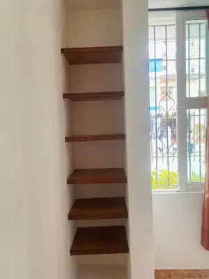a book shelf in a room with a window at Cartagena Kings Hostel in Cartagena de Indias