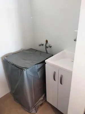a bathroom with a trash can next to a sink at Distrito 90 in Barranquilla