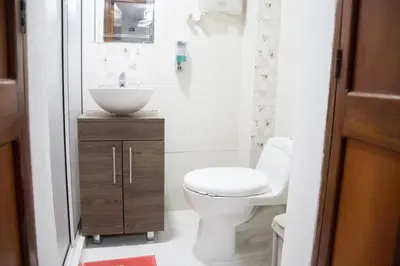 a bathroom with a white toilet and a sink at Apartamento en Caribe campestre Coveñas in Coveñitas
