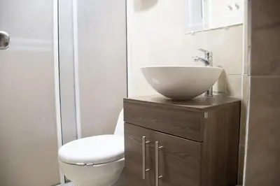 a bathroom with a sink and a toilet at Apartamento en Caribe campestre Coveñas in Coveñitas