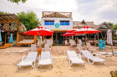 a group of chairs and umbrellas on a beach at Solarium Beach Club in Playa Blanca