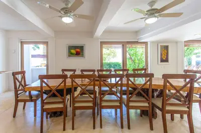 a dining room with a wooden table and chairs at dhozt Marlinda Beach House. Cartagena Colombia in Cartagena de Indias